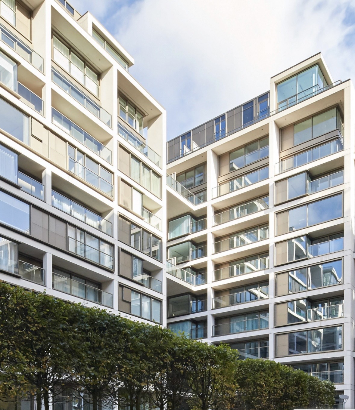 Modern multi-storey apartment buildings with floor-to-ceiling glazing and private balconies in central London
